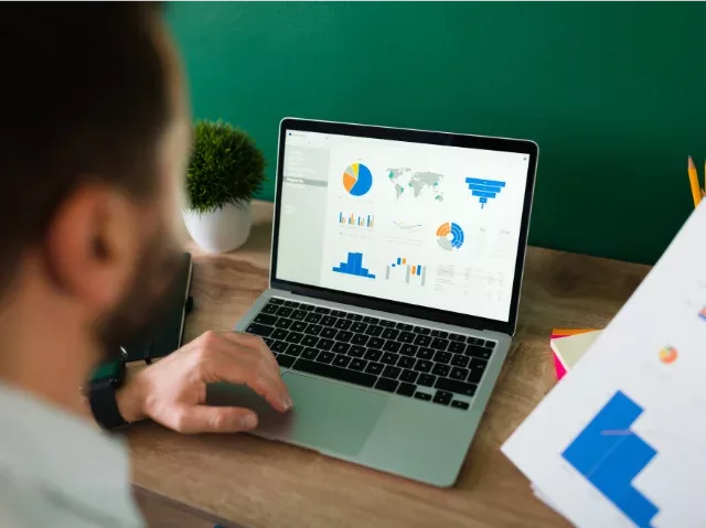 analyzing charts and graphs on a laptop