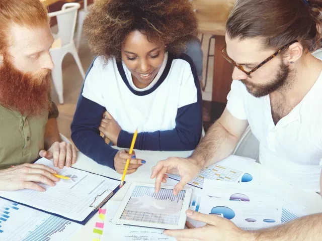 Three team members reviewing data